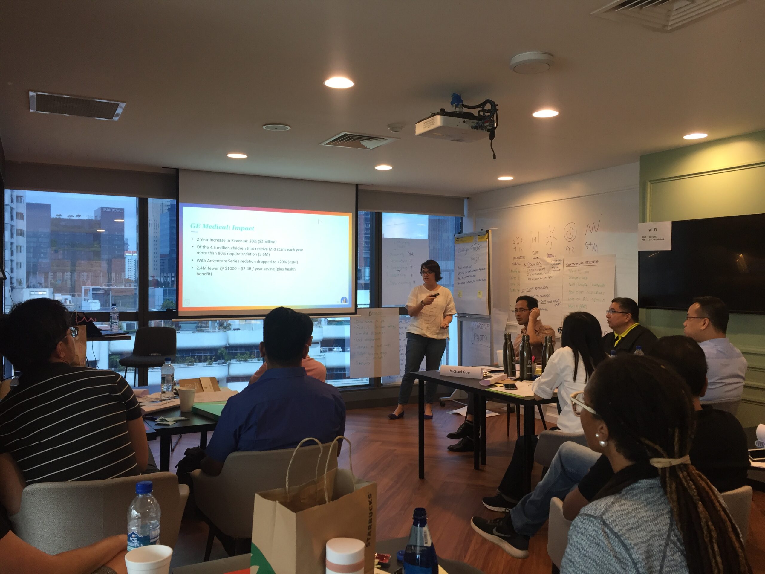 Woman teaching innovation to a room of corporate employee students