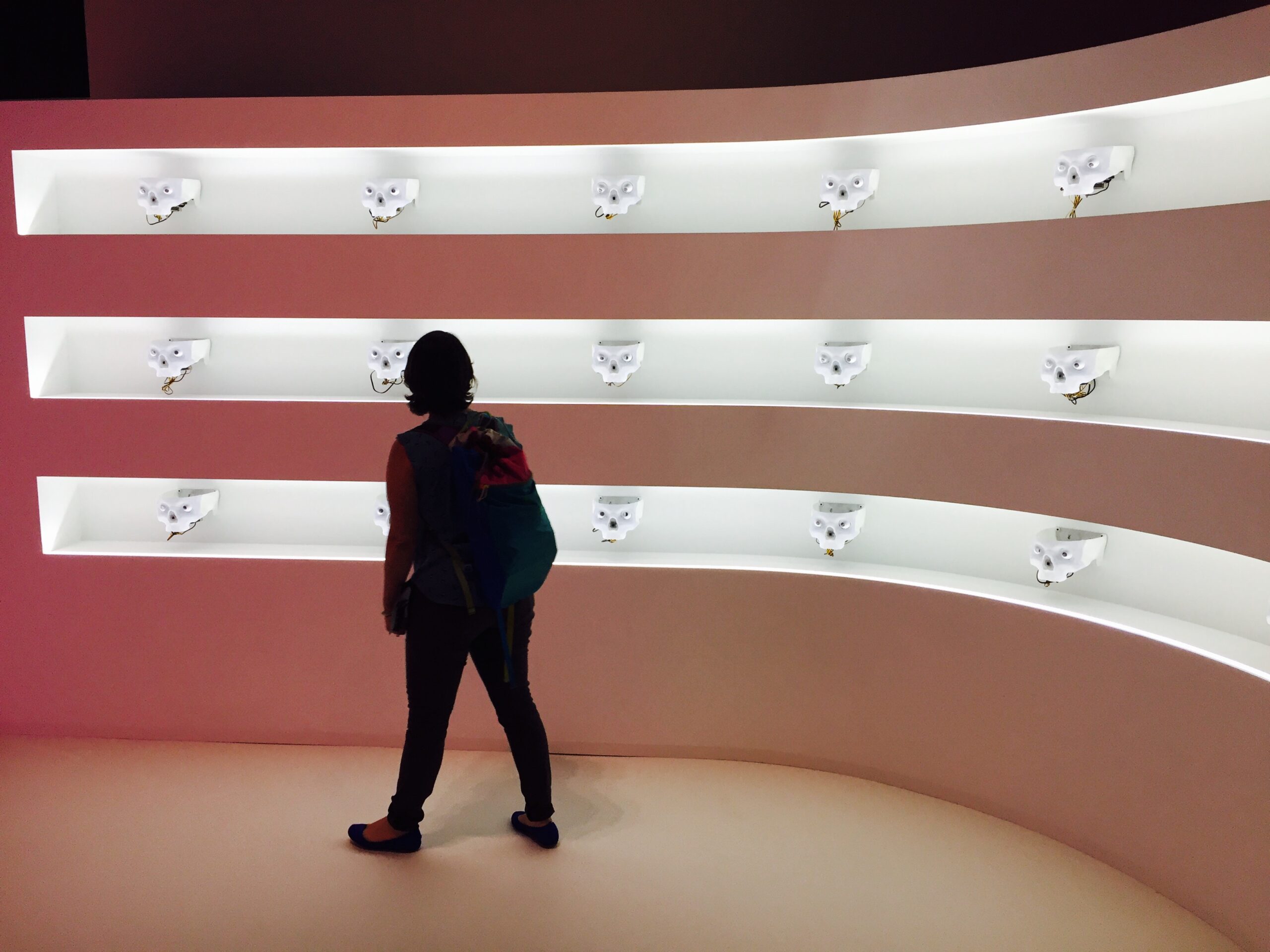 Woman walking in front of a futuristic exhibit at a musuem in Singapore